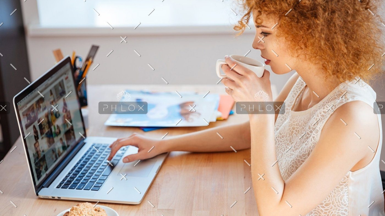 demo-attachment-1146-woman-photographer-drinking-coffee-and-working-PJNBP6U